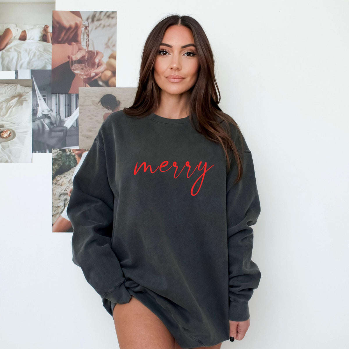 Model wearing a pepper gray crewneck sweatshirt with merry in red cursive