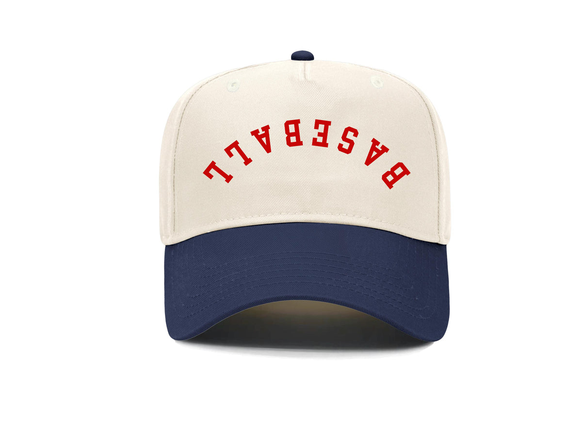 Upside-down Baseball embroidered snapback hat, natural front with navy brim and red arched lettering