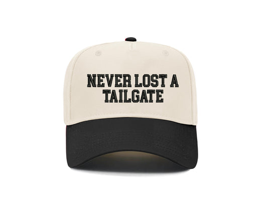 Never Lost a Tailgate embroidered snapback hat, natural front with black brim and black block lettering